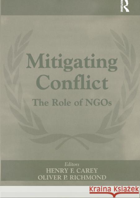 Mitigating Conflict: The Role of Ngos Carey, Henry F. 9780714684062 Frank Cass Publishers